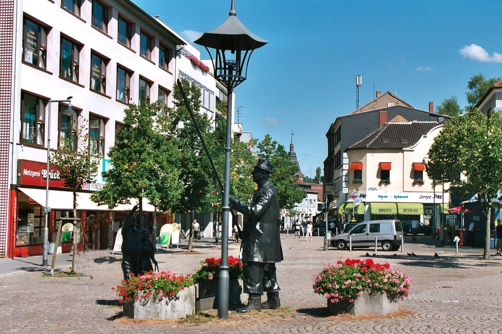 Marktplatz in Dudweiler mit Bronzefigur und Blumenkübeln